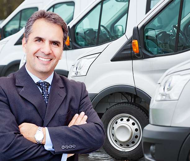 Manager standing in front of Business fleet vehicle vans in Townsville