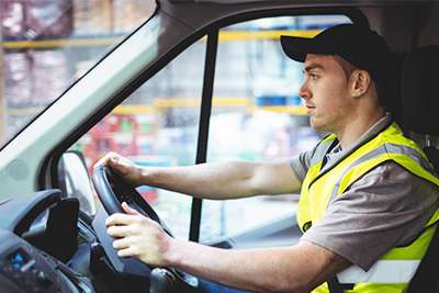 Townsville delivery driver in van behind steering wheel