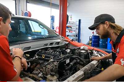 Townsville mechanics inspect fleet vehicle engine after service