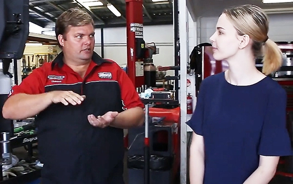 Townsville mechanic explains car repairs to young woman