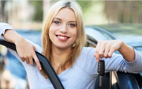 Townsville woman holds car key after buying a new car